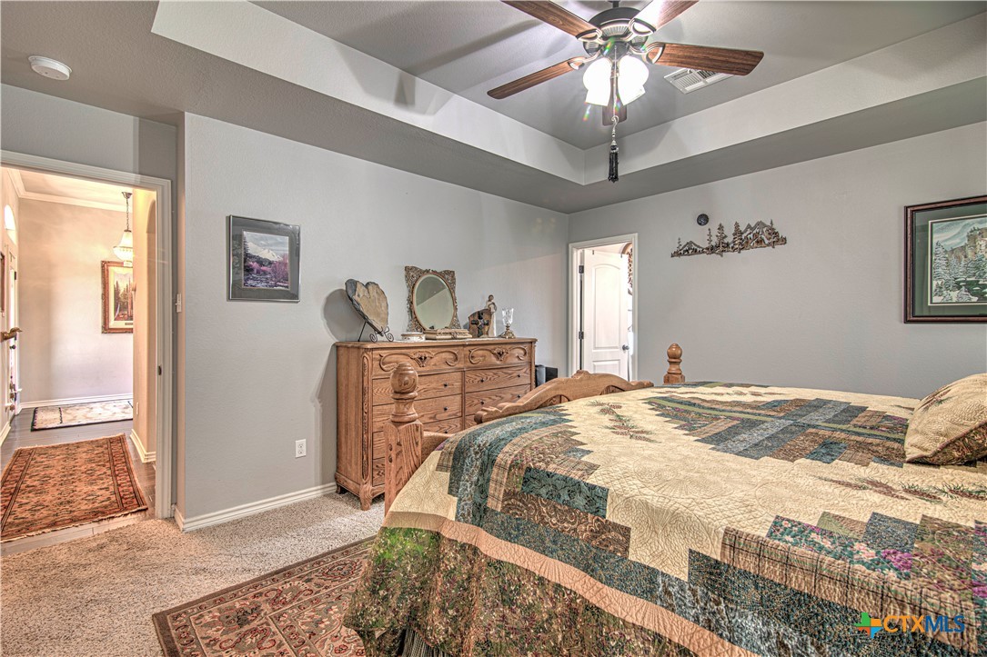412 Dandridge Drive Temple, TX 76502 - Photo 22 of 44 a bed sitting in a bedroom and chandelier