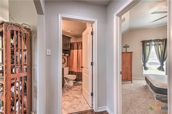 a view of a bedroom from a corridor