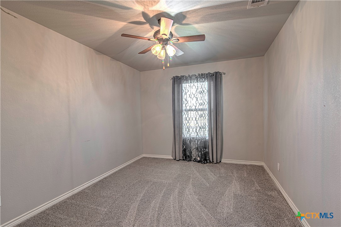 412 Dandridge Drive Temple, TX 76502 - Photo 29 of 44 an empty room with windows and chandelier fan