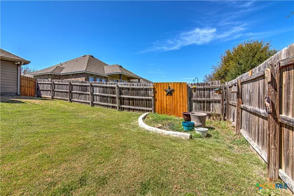 a backyard of a house with table and chairs