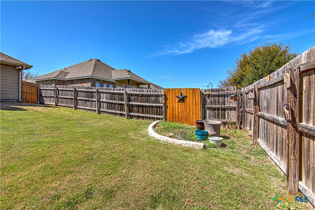 412 Dandridge Drive Temple, TX 76502 - Photo 36 of 44 a backyard of a house with table and chairs