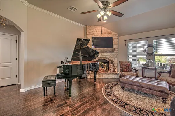 a living room with furniture and wooden floor