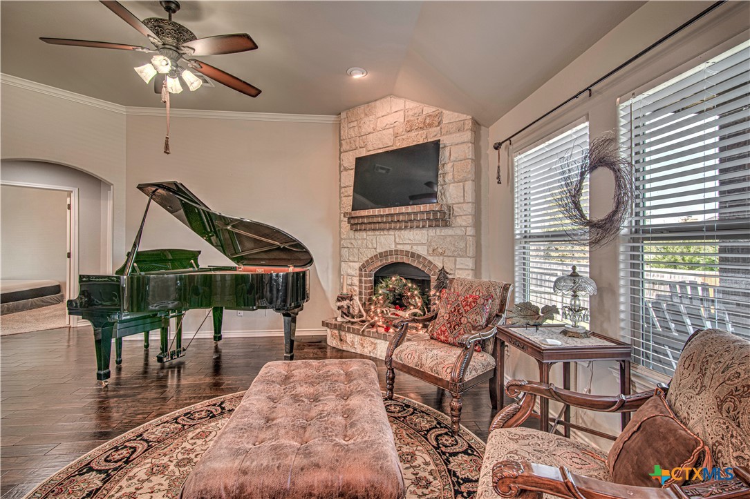 412 Dandridge Drive Temple, TX 76502 - Photo 10 of 44 a living room with furniture a fireplace and a flat screen tv