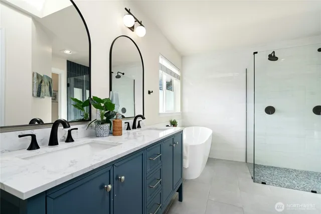 a spacious bathroom with a double vanity sink mirror and double