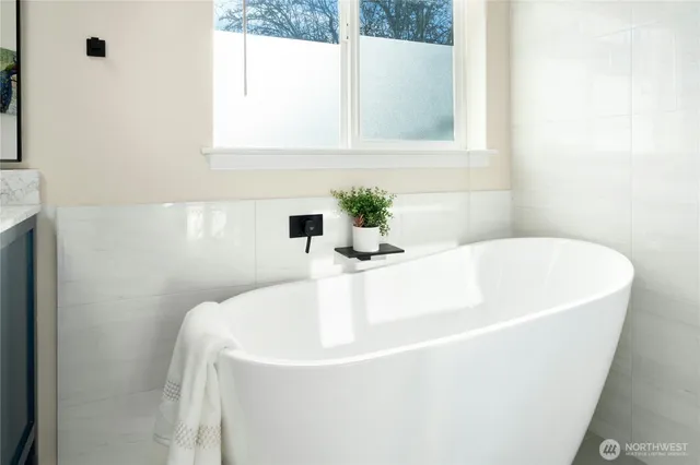a white bath tub sitting in a bathroom