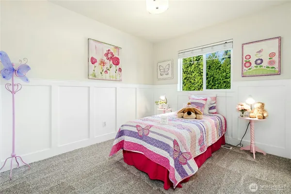 a bedroom with a bed and a painting on the wall