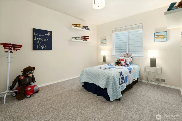 a bed sitting in a bedroom next to a window