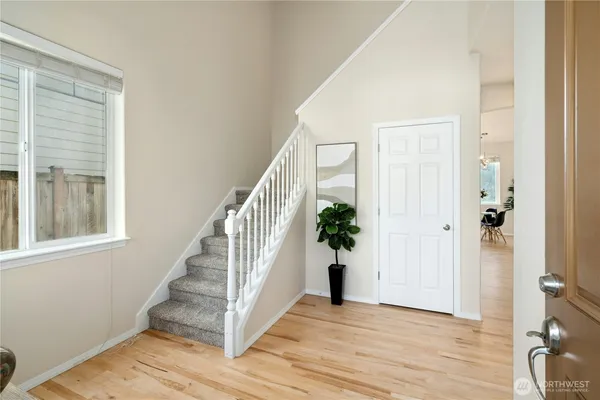a view of an entryway with wooden floor and stairs