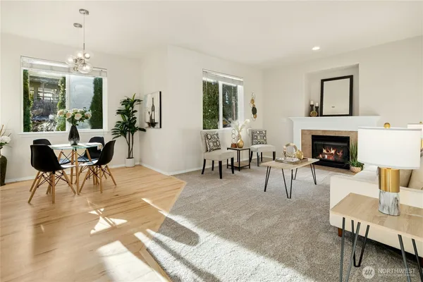 a living room with furniture a table and a fireplace