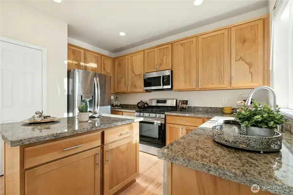 a kitchen with sink a window and cabinets