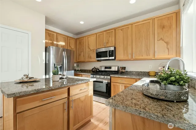 a kitchen with sink a window and cabinets
