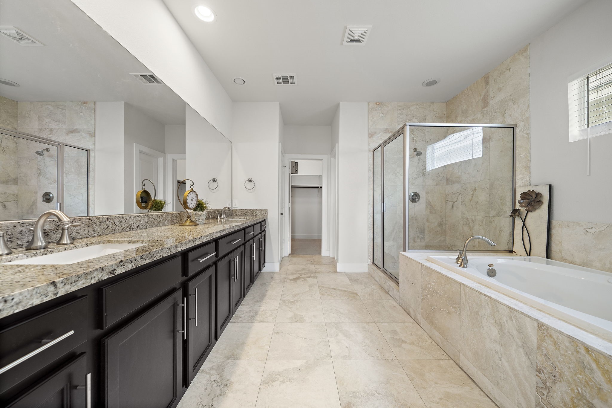9517 Cedarpost Square Street Houston, TX 77055 - Photo 12 of 20 a spacious bathroom with a granite countertop tub sink and mirror