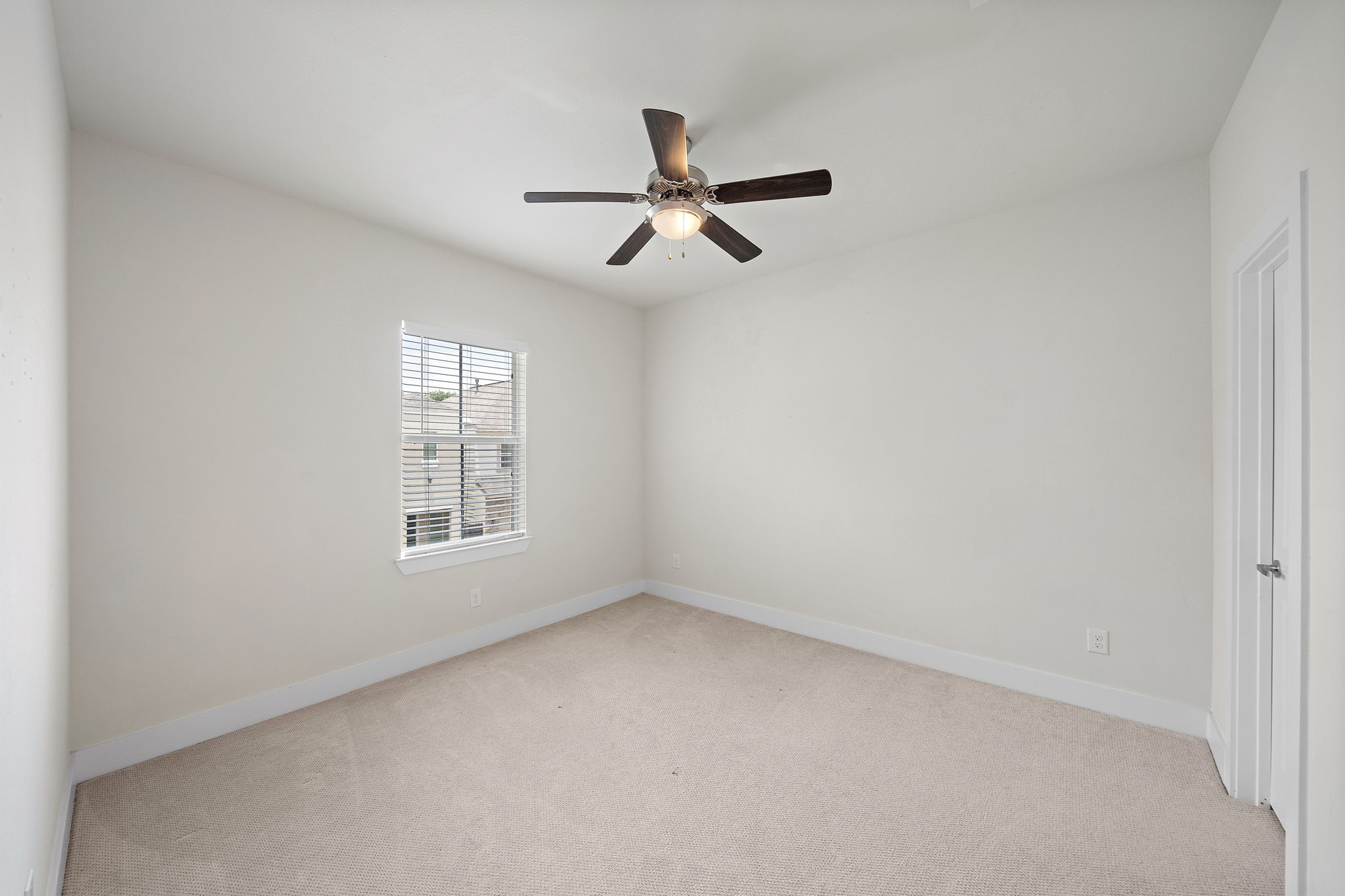 9517 Cedarpost Square Street Houston, TX 77055 - Photo 16 of 20 an empty room with a window and a fan