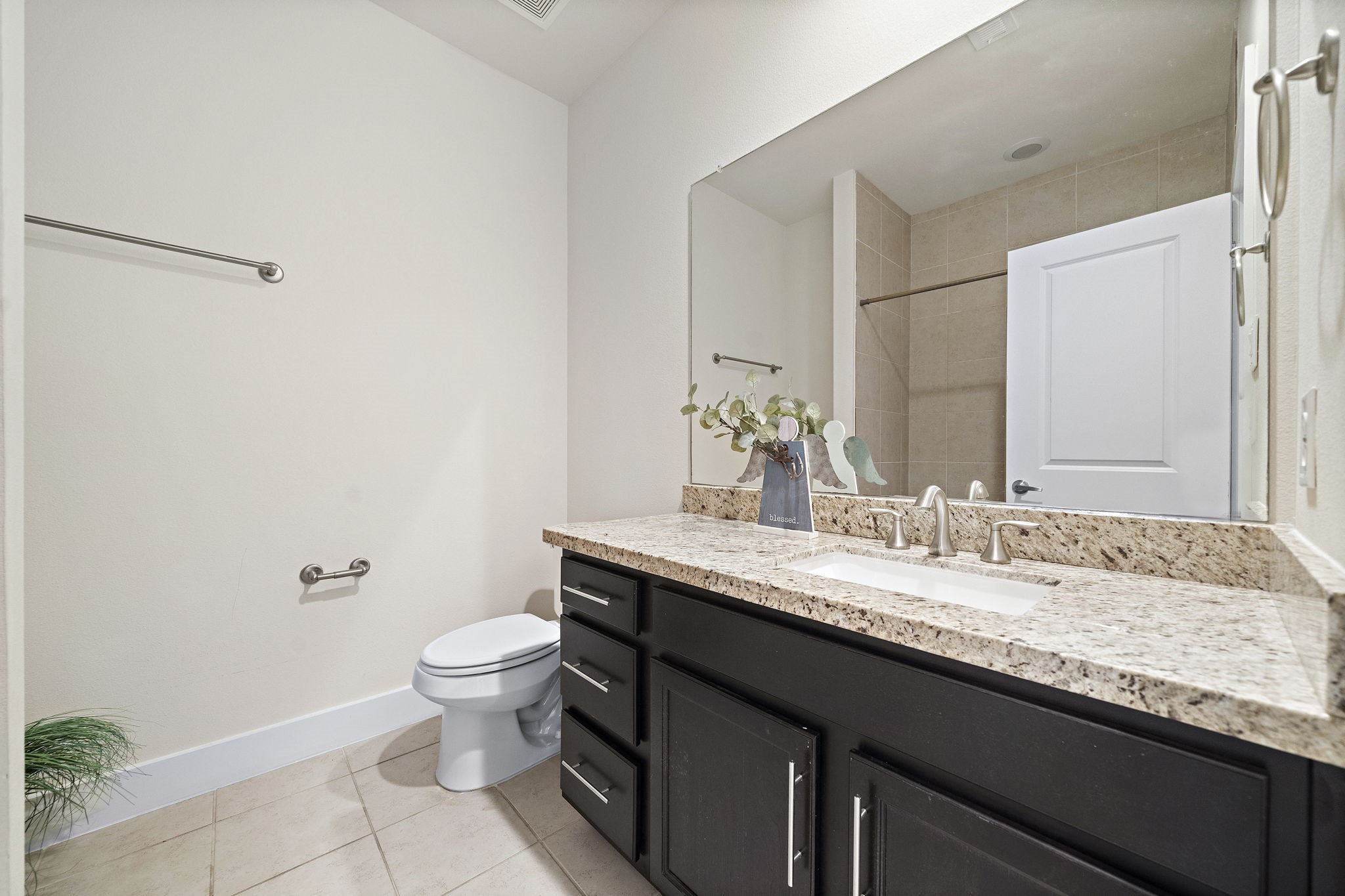 9517 Cedarpost Square Street Houston, TX 77055 - Photo 17 of 20 a bathroom with a granite countertop sink a toilet and a mirror