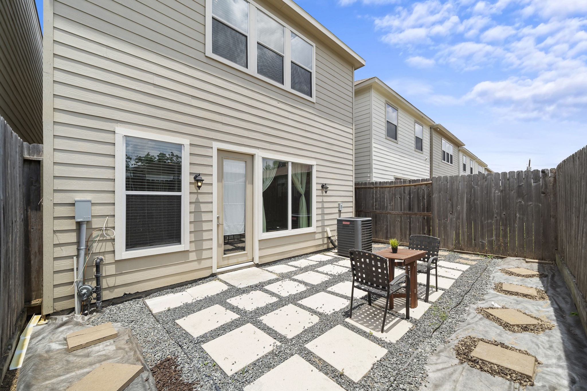9517 Cedarpost Square Street Houston, TX 77055 - Photo 20 of 20 a view of a patio with table and chairs and wooden fence