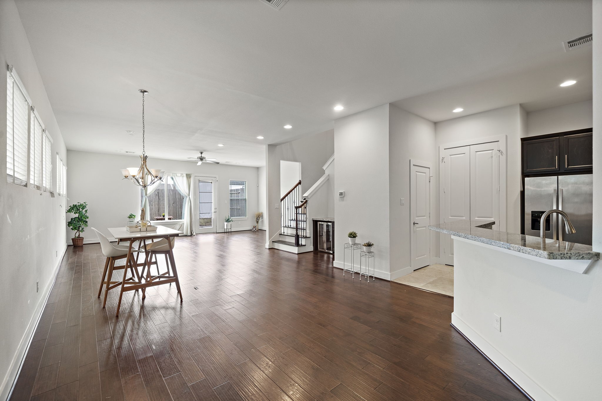 9517 Cedarpost Square Street Houston, TX 77055 - Photo 3 of 20 a view of a dining room and livingroom with furniture wooden floor a chandelier