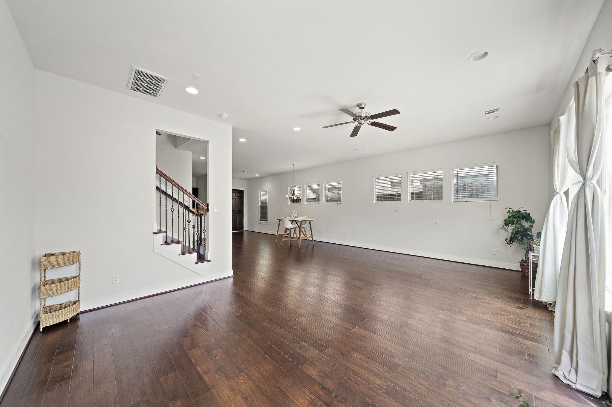 9517 Cedarpost Square Street Houston, TX 77055 - Photo 5 of 20 a view of a livingroom with wooden floor and a ceiling fan