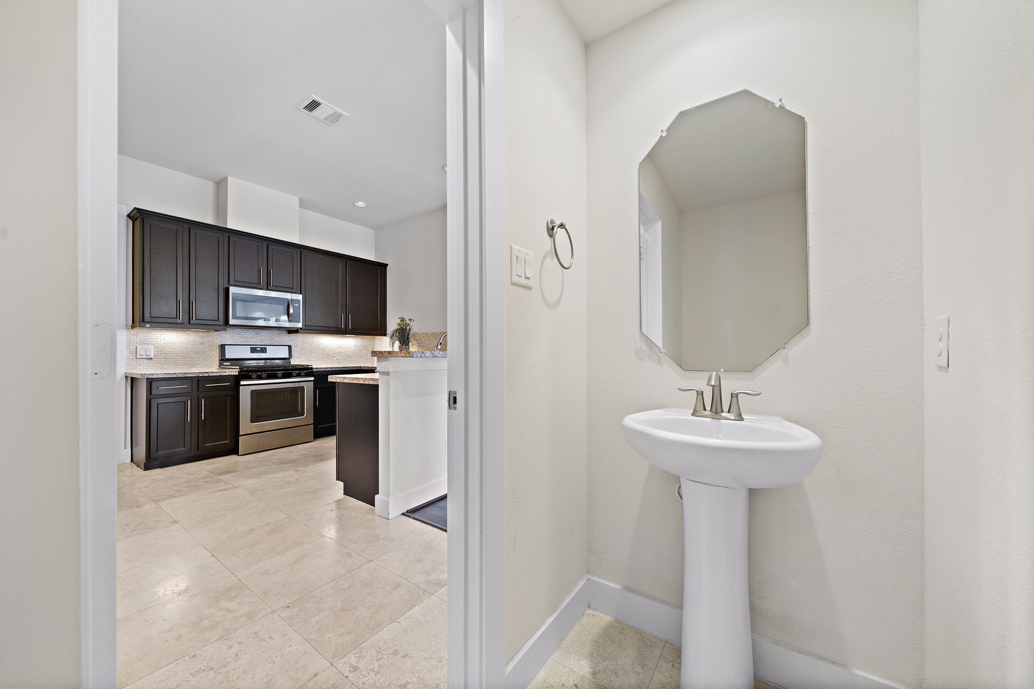 9517 Cedarpost Square Street Houston, TX 77055 - Photo 9 of 20 a kitchen with stainless steel appliances a sink stove and refrigerator