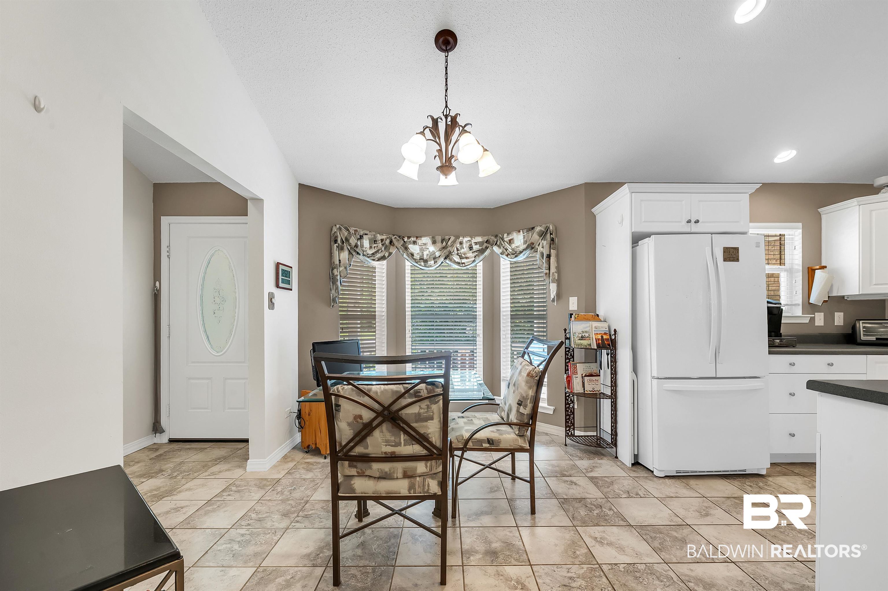 9908 Clarke Ridge Road Foley, AL 36535 - Photo 29 of 56 Dining space with baseboards, a notable chandelier, and recessed lighting
