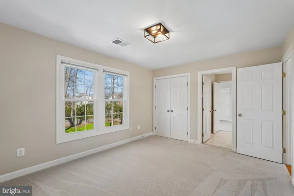 a view of an empty room with a ceiling fan