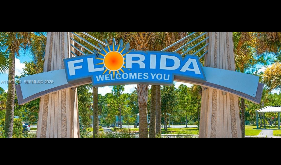 2363 Jacobs Street Port Charlotte, FL 33953 - Photo 12 of 12 a blue sign that is on the wall of a building