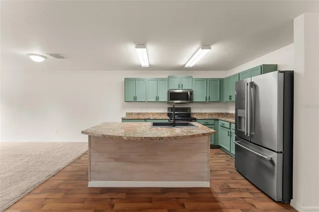 a kitchen with counter top space and stainless steel appliances