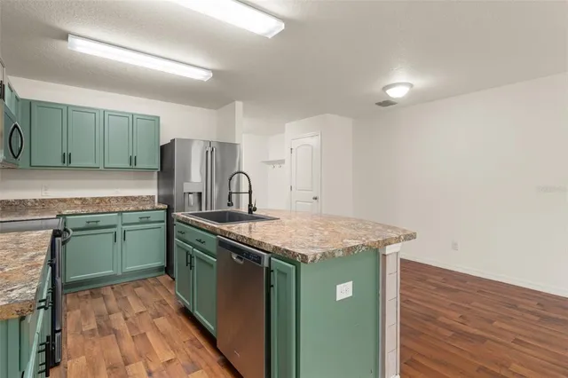 a kitchen with a sink and a refrigerator