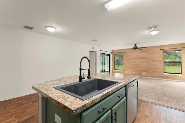 a kitchen that has a sink and a stove