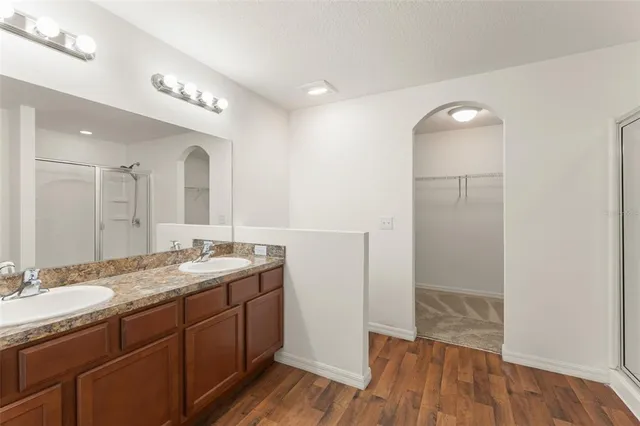 a spacious bathroom with a granite countertop sink a mirror and a