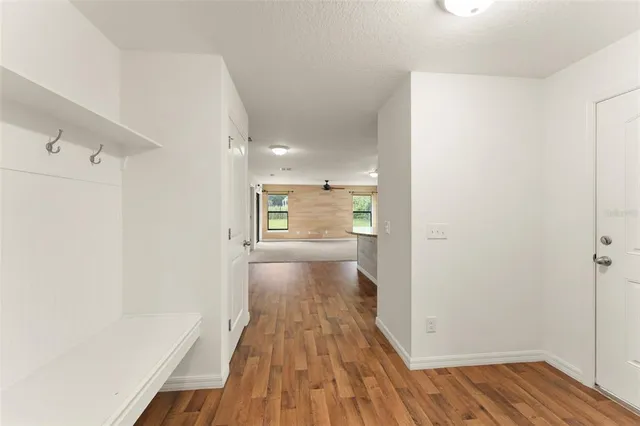 a view of a hallway with wooden floor