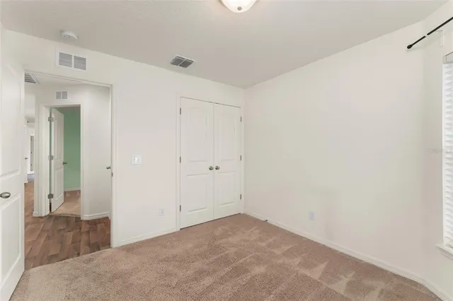 an empty room with wooden floor