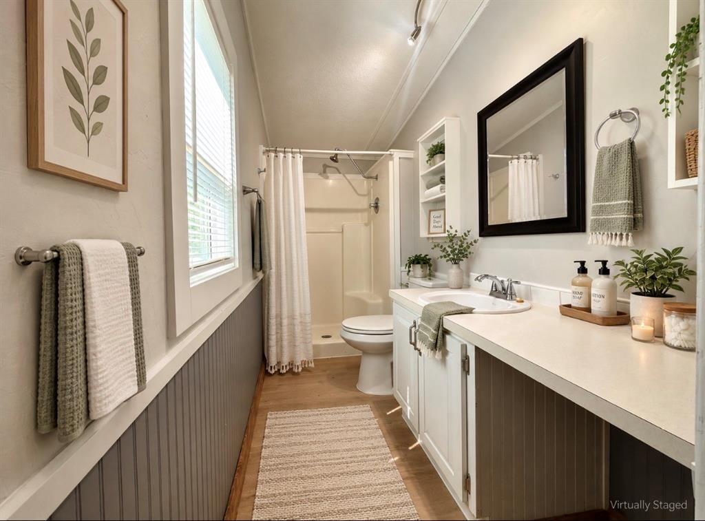 4676 Old Dallas Road Elm Mott, TX 76640 - Photo 13 of 21 White vanity with an integrated sink and extensive countertop space, complemented by a framed mirror