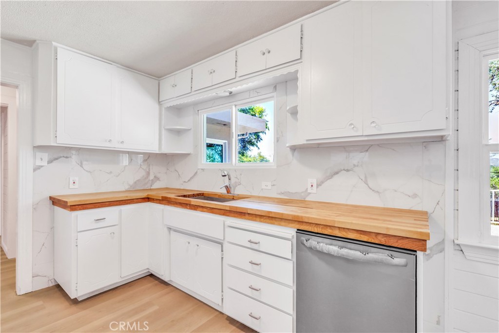 15905 Kugelman Street Lower Lake, CA 95457 - Photo 57 of 75 a kitchen with white cabinets and a sink