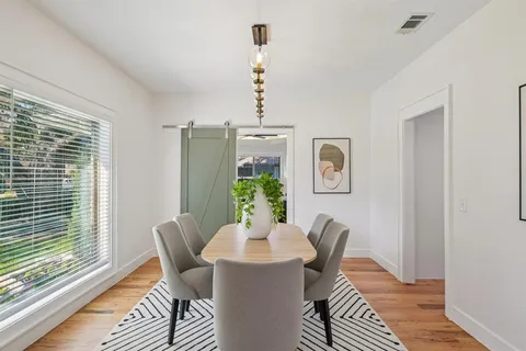 a view of a dining room with furniture window and wooden floor