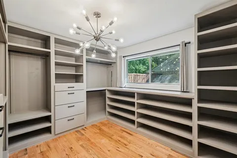 a view of walk in closet and window