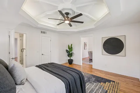 a bedroom with a bed and a chandelier