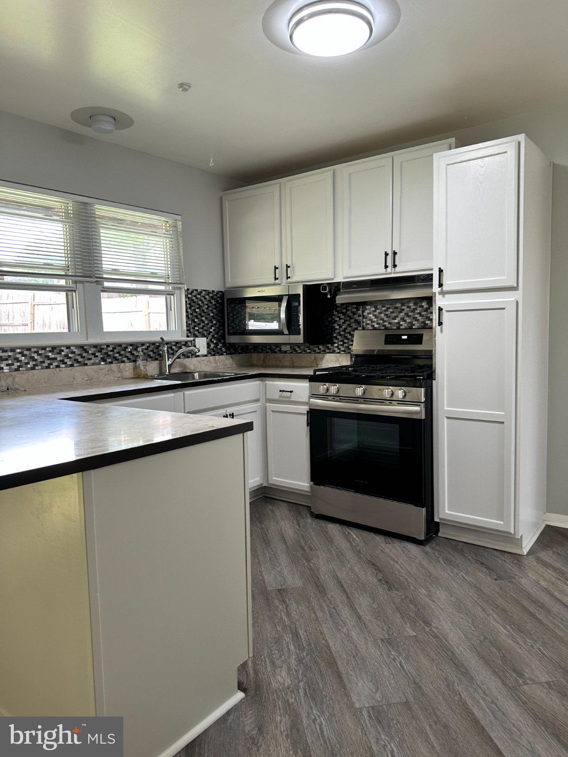 8336 Scotts Level Road Baltimore, MD 21208 - Photo 17 of 55 Modern kitchen with sleek finishes.