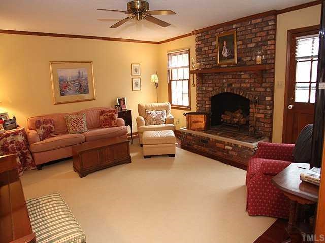 7517 Old Hundred Road Raleigh, NC 27613 - Photo 2 of 12 a living room with furniture and a fireplace