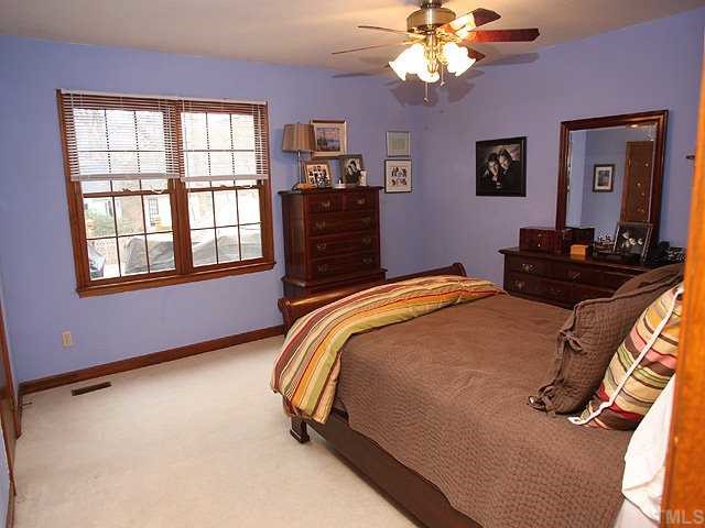 7517 Old Hundred Road Raleigh, NC 27613 - Photo 5 of 12 a bedroom with a bed dresser and window