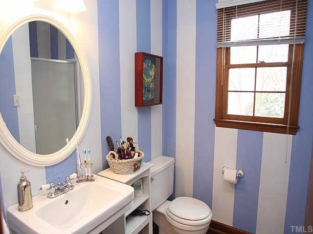 7517 Old Hundred Road Raleigh, NC 27613 - Photo 6 of 12 a bathroom with a toilet sink and mirror