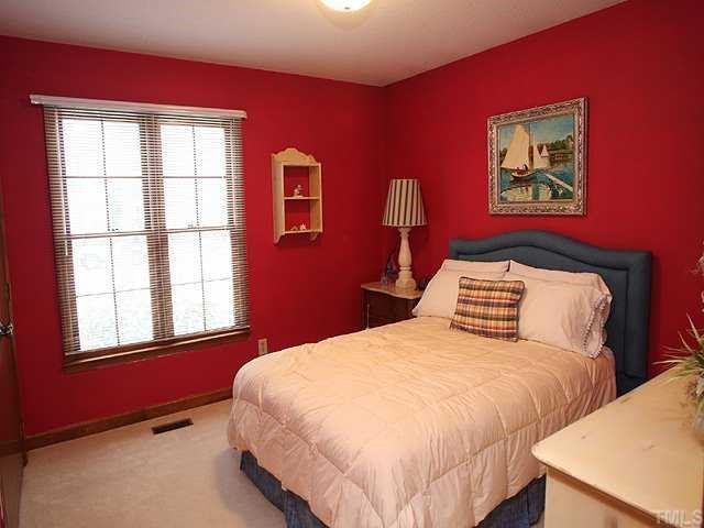 7517 Old Hundred Road Raleigh, NC 27613 - Photo 7 of 12 a bedroom with bed and two windows