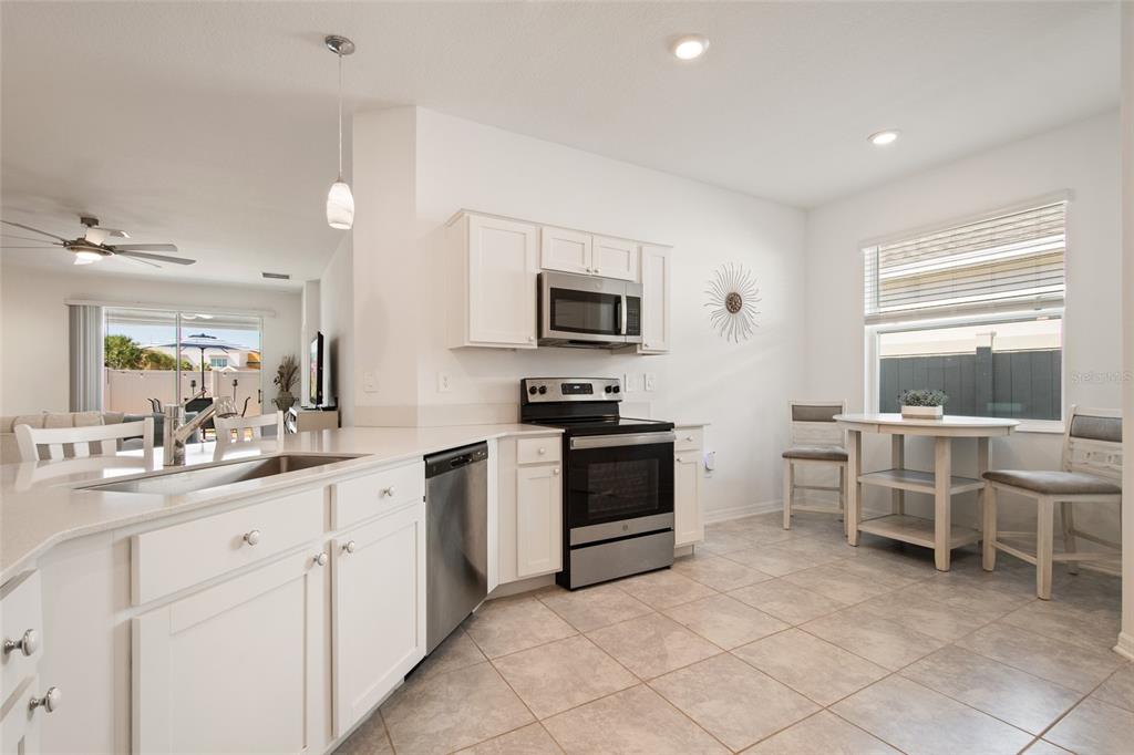 1172 Tyler Loop Lake Wales, FL 33859 - Photo 11 of 56 a kitchen with cabinets and chairs