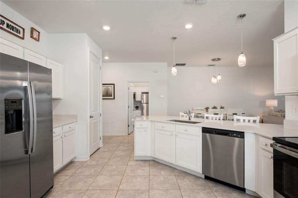 1172 Tyler Loop Lake Wales, FL 33859 - Photo 14 of 56 a kitchen with a sink and refrigerator
