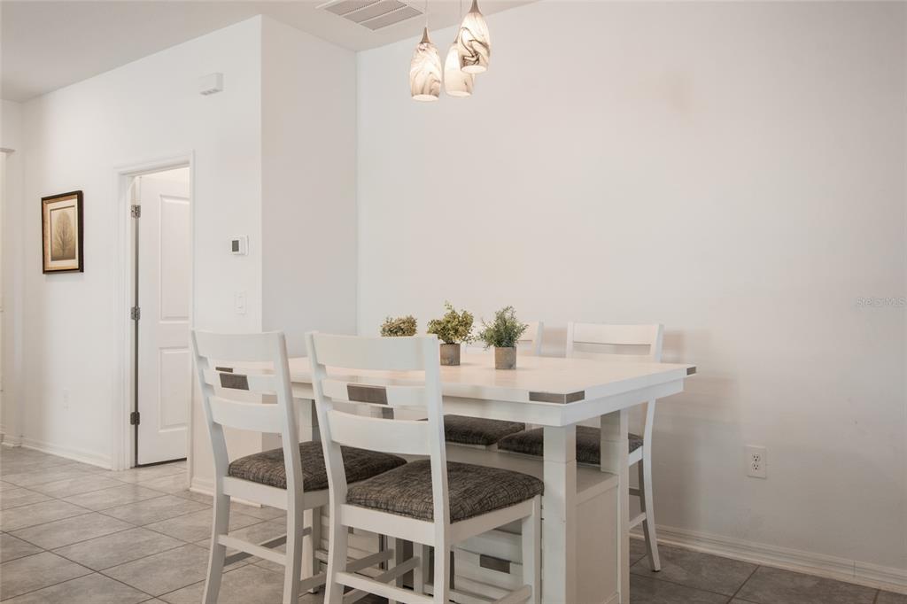 1172 Tyler Loop Lake Wales, FL 33859 - Photo 16 of 56 a view of a dining room with furniture and wooden floor