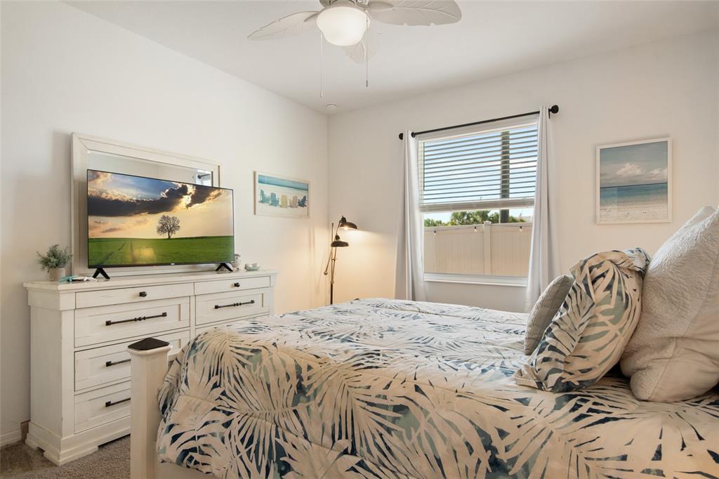 1172 Tyler Loop Lake Wales, FL 33859 - Photo 26 of 56 a bedroom with a bed and a flat screen tv in it