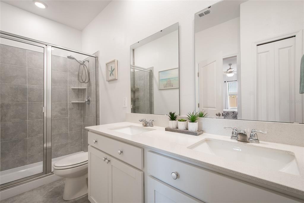 1172 Tyler Loop Lake Wales, FL 33859 - Photo 28 of 56 a bathroom with a shower sink vanity mirror and toilet