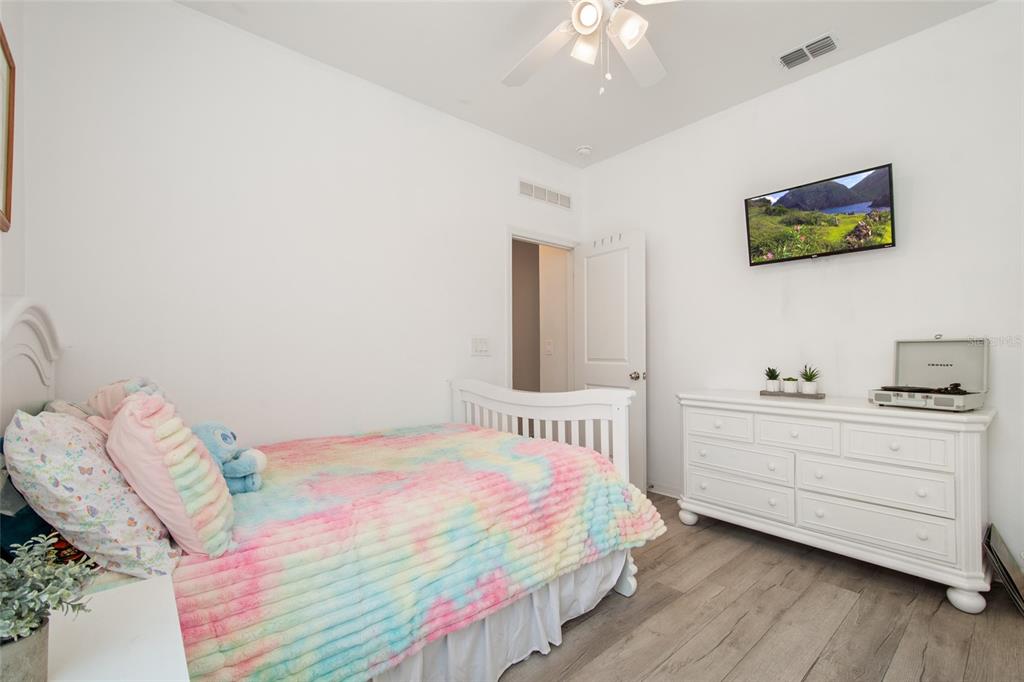 1172 Tyler Loop Lake Wales, FL 33859 - Photo 31 of 56 a bedroom with a bed and a chandelier