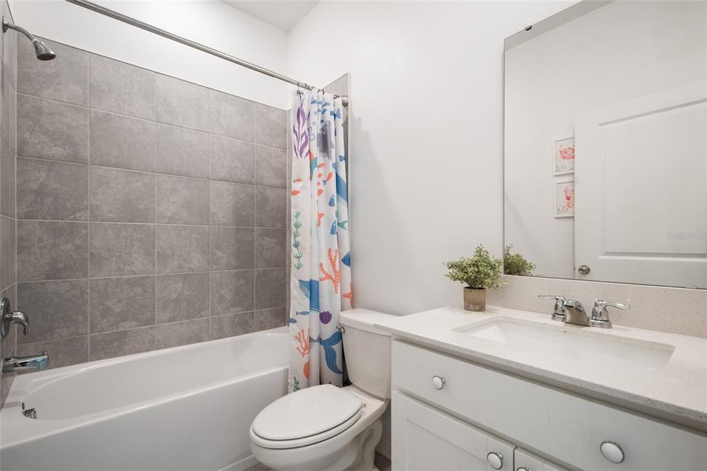 1172 Tyler Loop Lake Wales, FL 33859 - Photo 32 of 56 a bathroom with a granite countertop bathtub shower sink vanity mirror and toilet