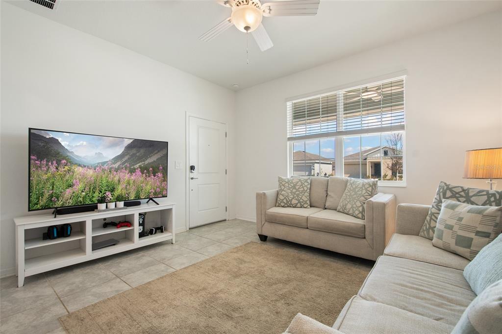 1172 Tyler Loop Lake Wales, FL 33859 - Photo 37 of 56 a living room with furniture and a flat screen tv