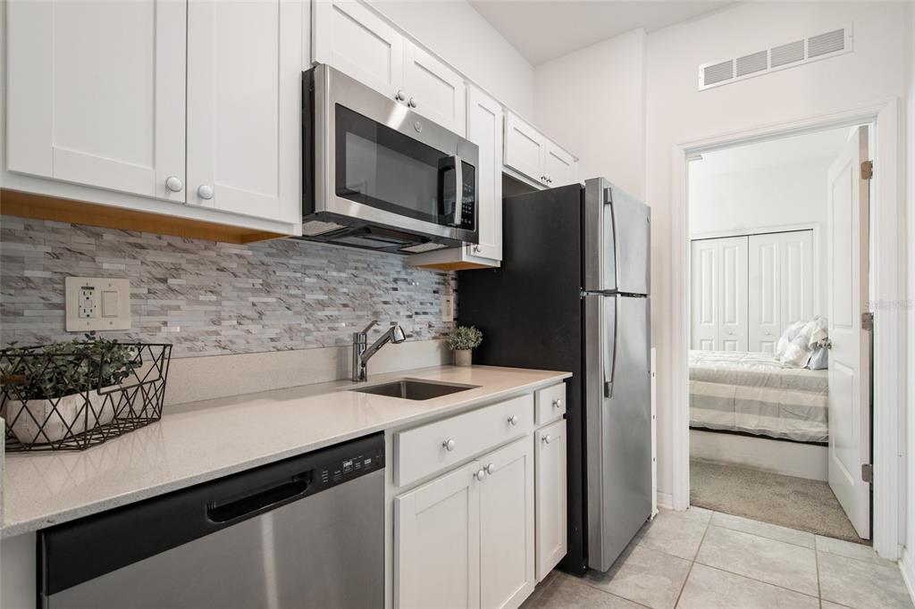 1172 Tyler Loop Lake Wales, FL 33859 - Photo 38 of 56 a kitchen with a sink and refrigerator
